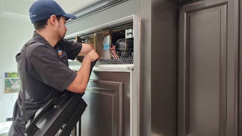 Mesa Location Page Someone repairing a refrigerator by Dynamic Appliance Repair