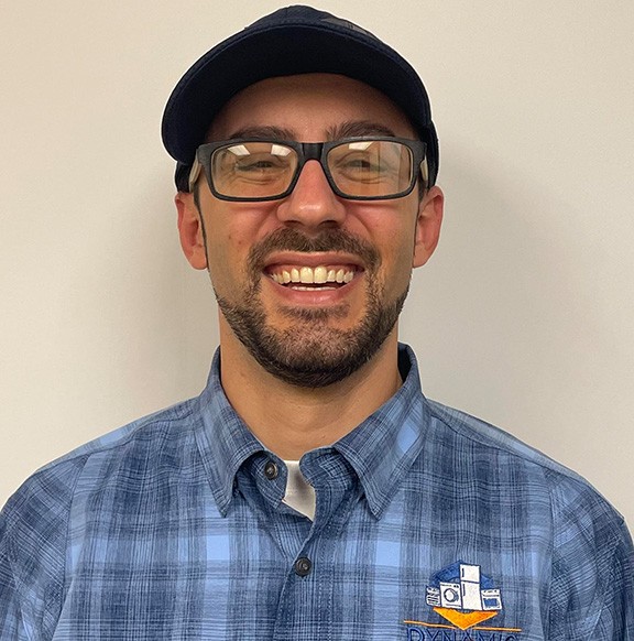 greg Greg, a technician from Dynamic Appliance Repair, wearing glasses and a blue shirt<br />