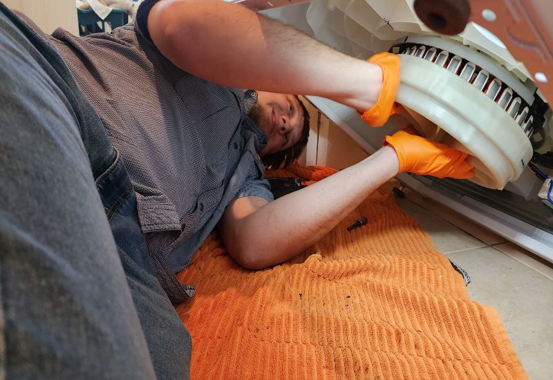 An expert team member is repairing a washer in Gilbert & Fountain Hills, AZ<br />
