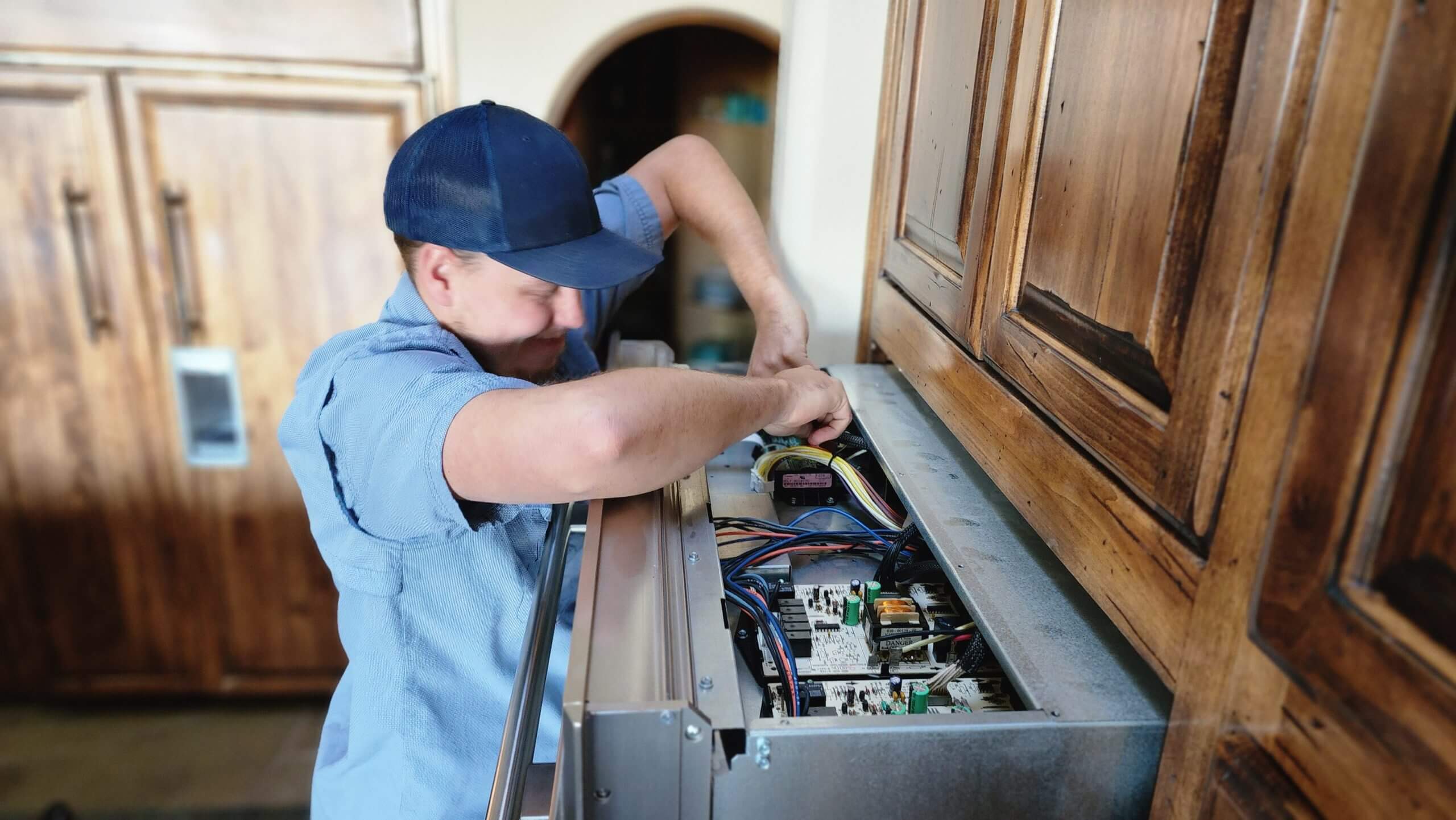 Technician repairing dishwasher control panel in Gilbert and Fountain Hills, AZ