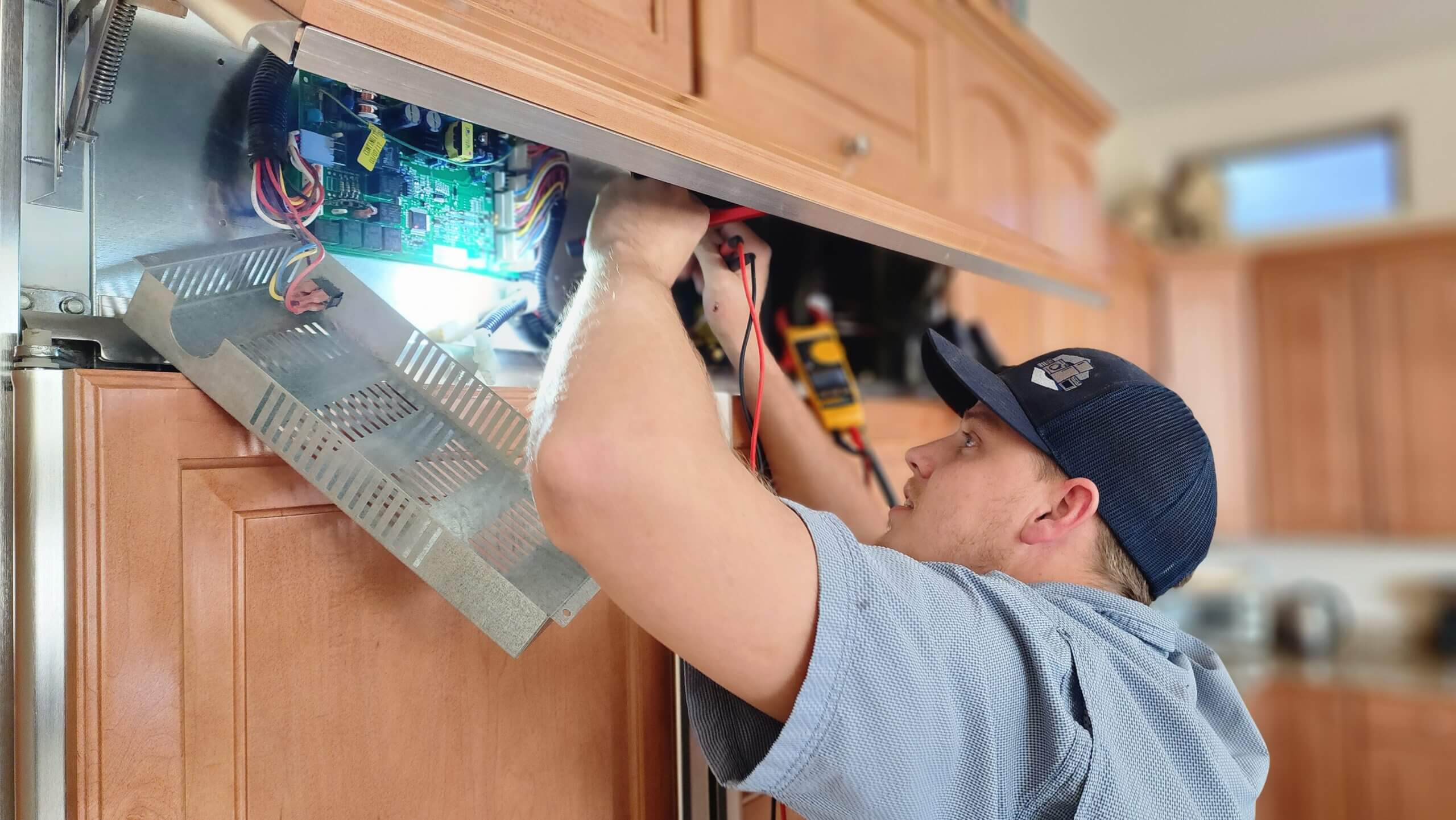 Technician repairing refrigerator control board in Gilbert and Fountain Hills, AZ