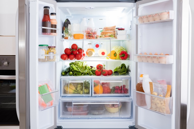 Organized refrigerator with fresh food and beverages demonstrating proper cooling performance in Fountain Hills, AZ