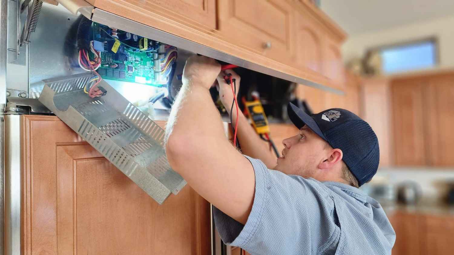refrigerator-control-board HVAC tech testing furnace control board in Gilbert & Fountain Hills, AZ<br />