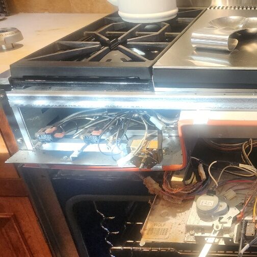 Technicians are performing range repair in a kitchen in Gilbert & Fountain Hills, AZ