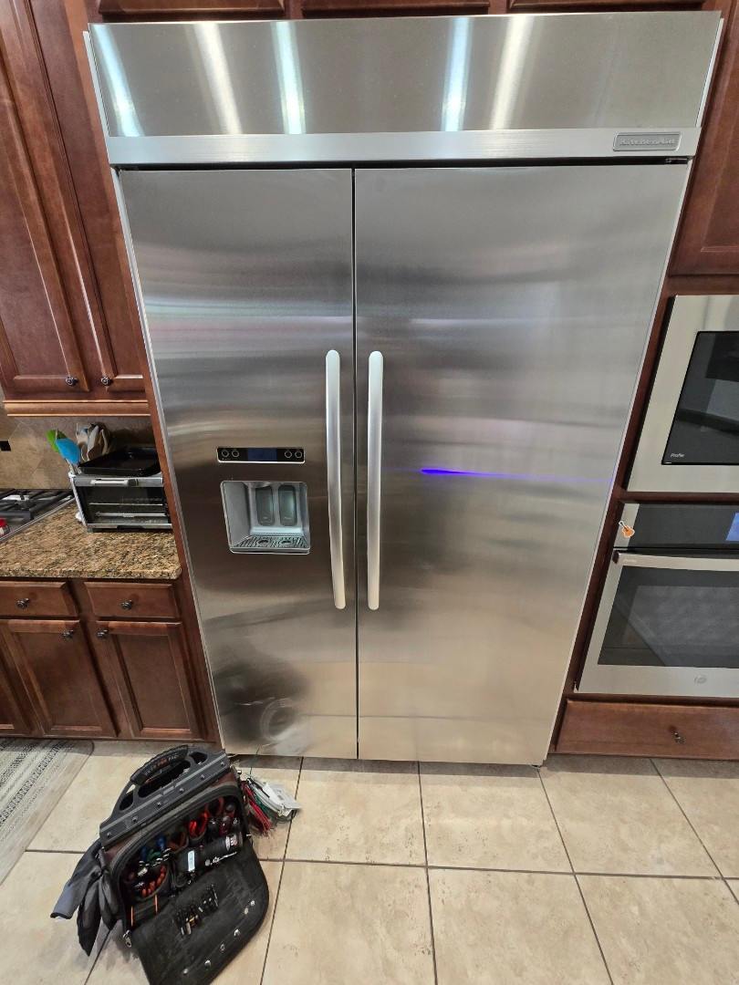 Double-door stainless steel refrigerator in a residential kitchen in Gilbert & Fountain Hills, AZ<br />
